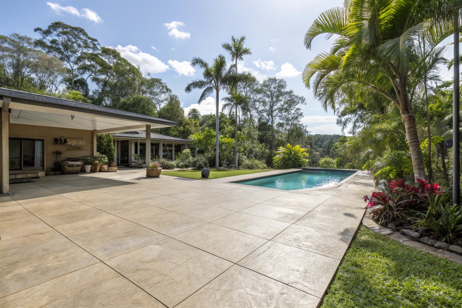 Concrete pool surround and patio at a Gold Coast residential property