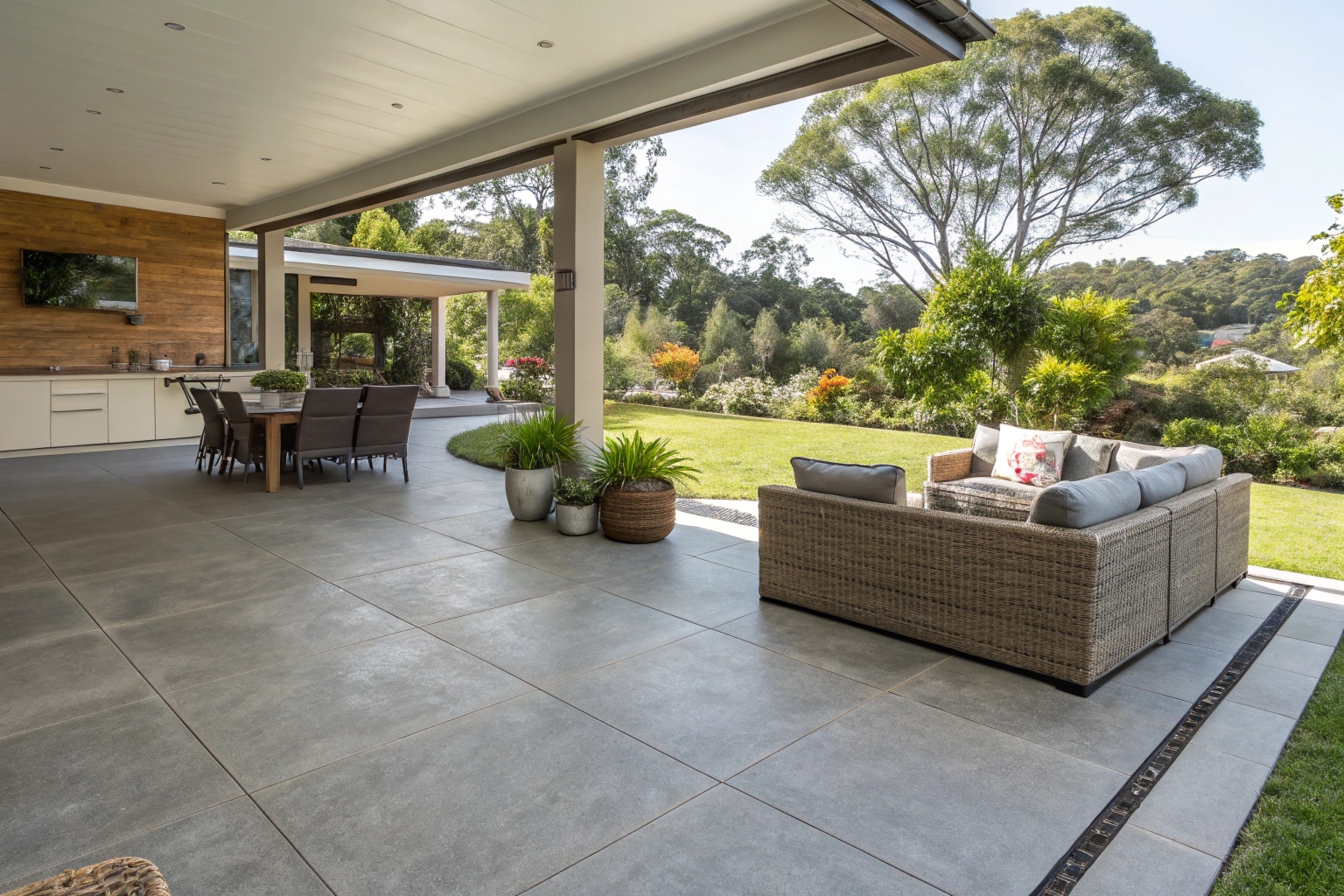 Coloured concrete patio in warm grey finish at a Gold Coast outdoor alfresco entertaining area