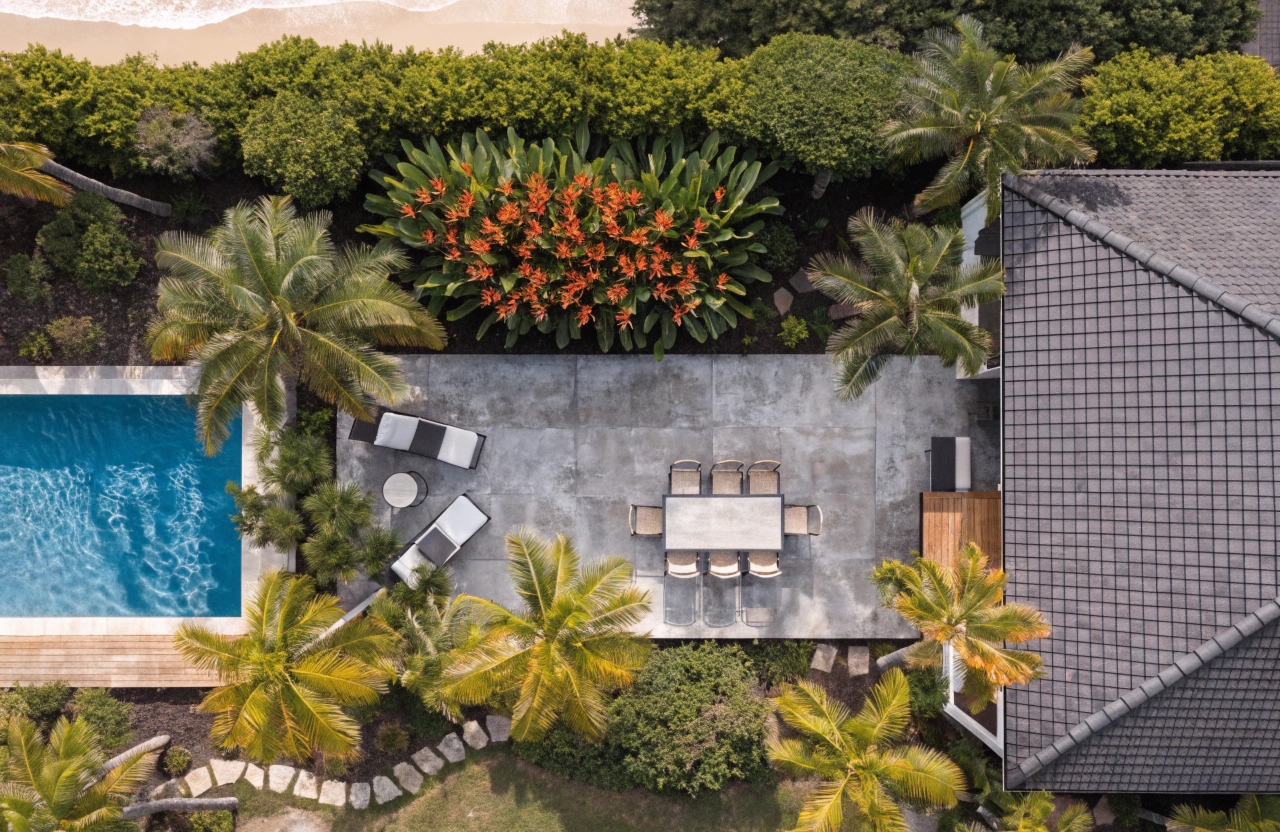 Honed concrete alfresco entertaining area and pool surround at a Burleigh Heads residence
